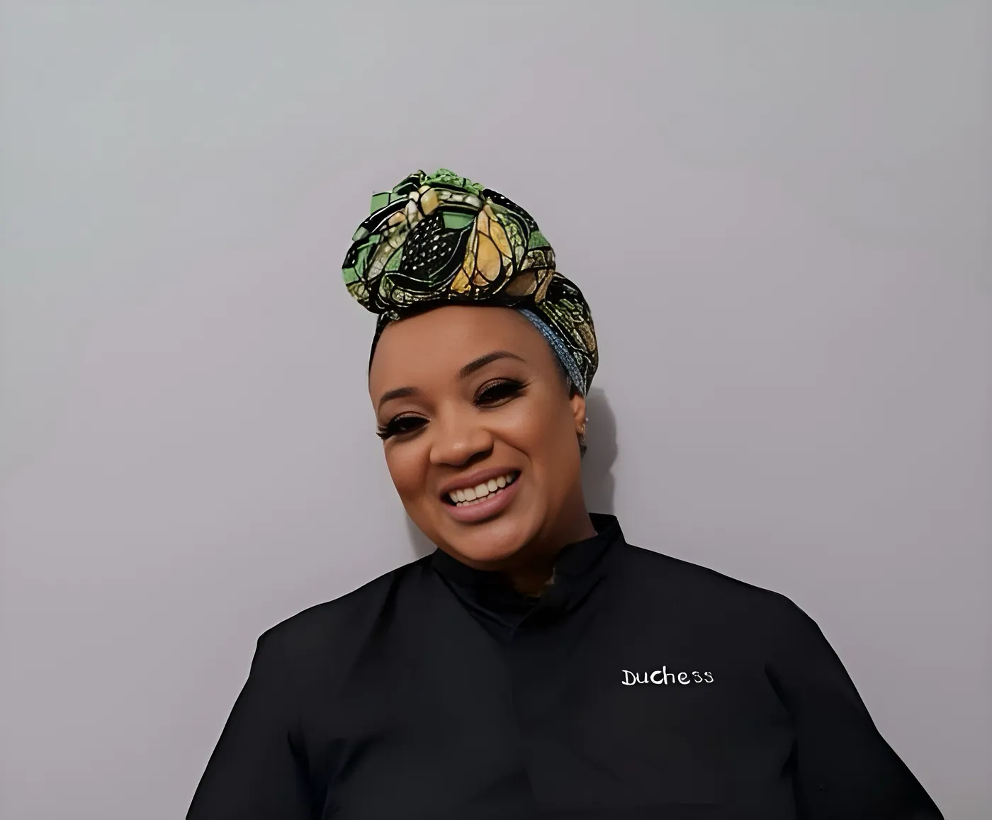 Duchess Nena in her chef's jacket and headwrap